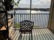 Enjoy the gorgeous lake view from this inviting balcony with a comfortable chair at 1909 Summer Club Dr # 307, Oviedo, FL 32765