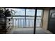 Relaxing balcony area offering serene views of the lake, complete with cozy furnishings at 1909 Summer Club Dr # 307, Oviedo, FL 32765