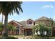 Exterior of a charming clubhouse featuring classic architectural details and landscaped surroundings at 1909 Summer Club Dr # 307, Oviedo, FL 32765