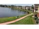 Scenic lake view with walking path, bench, and multi-story residential buildings in a well-maintained community at 1909 Summer Club Dr # 307, Oviedo, FL 32765