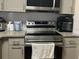 Close up of the modern stainless steel range and appliances at 1909 Summer Club Dr # 307, Oviedo, FL 32765