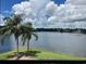 Scenic lake view with palm trees and a fountain, enhancing the natural beauty of the community at 1909 Summer Club Dr # 307, Oviedo, FL 32765