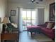 Comfortable living room features access to balcony, providing serene views at 1909 Summer Club Dr # 307, Oviedo, FL 32765