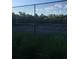 Outdoor tennis court with manicured landscaping and a sturdy fence for privacy and safe play at 1909 Summer Club Dr # 307, Oviedo, FL 32765