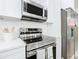 Modern kitchen featuring stainless steel appliances and white cabinets at 4902 Pall Mall E St, Kissimmee, FL 34758