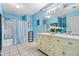 Bathroom with double vanity, light-colored cabinets, and tiled floor at 4420 Hamlet Ct, Kissimmee, FL 34746