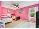 Bedroom with a twin bed, pink walls, and a ceiling fan at 4420 Hamlet Ct, Kissimmee, FL 34746