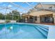 Relaxing screened-in pool with patio and a hammock at 4420 Hamlet Ct, Kissimmee, FL 34746