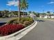 Landscaped entrance to the community with palm trees and a circular driveway at 9440 Golden Laurel Ln, Orlando, FL 32827