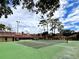 Green tennis court with surrounding buildings at 1150 Carmel Cir # 201, Casselberry, FL 32707