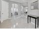 Bright and spacious entryway with elegant tile floors and a modern console table at 8168 Via Bella Notte, Orlando, FL 32836