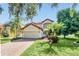 Two-story house with a red tile roof, attached garage, and well-manicured lawn at 8168 Via Bella Notte, Orlando, FL 32836