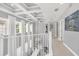 Bright hallway with high ceilings, white railings, and large windows at 8168 Via Bella Notte, Orlando, FL 32836