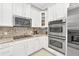 Stainless steel appliances and granite countertops in this kitchen at 8168 Via Bella Notte, Orlando, FL 32836