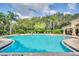 Community pool with lounge chairs and shaded areas at 8168 Via Bella Notte, Orlando, FL 32836