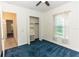 Well-lit bedroom with a closet, window with curtains and blue carpet at 18920 Overton St, Orlando, FL 32833