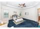 Large main bedroom with dark blue carpet and seating area at 18920 Overton St, Orlando, FL 32833