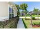 Sidewalk beside home leads to yard with arbor at 18920 Overton St, Orlando, FL 32833