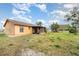 Exterior view of home with a large, grassy backyard at 3186 Mapleshade St, Deltona, FL 32738