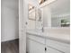 Bathroom with a modern sink vanity, framed mirror, and walk-in closet at 3186 Mapleshade St, Deltona, FL 32738