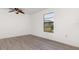 Inviting bedroom with modern floors, a ceiling fan, and a window that provides natural light at 3186 Mapleshade St, Deltona, FL 32738