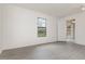 Bedroom with gray floors, white walls and ceilings, a window, and a fan at 3186 Mapleshade St, Deltona, FL 32738