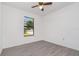 Bedroom featuring modern floors, a ceiling fan, and a window that provides natural light at 3186 Mapleshade St, Deltona, FL 32738