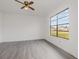 Bright bedroom with a large window, gray flooring, and neutral paint at 3186 Mapleshade St, Deltona, FL 32738