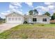 Charming single-story home with a two-car garage, manicured lawn, and welcoming front entrance at 3186 Mapleshade St, Deltona, FL 32738