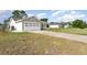 Spacious two-car garage with an extra-long driveway and a well-maintained lawn at 3186 Mapleshade St, Deltona, FL 32738