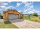 Spacious two-car garage with a patterned driveway and well-maintained lawn at 3186 Mapleshade St, Deltona, FL 32738