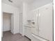 Well-equipped kitchen featuring white cabinets, a large refrigerator, and neutral floors at 3186 Mapleshade St, Deltona, FL 32738