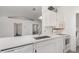 Modern kitchen featuring white cabinets, quartz countertops, stainless steel sink, and open to the living area at 3186 Mapleshade St, Deltona, FL 32738