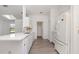 Open-concept kitchen features white cabinets, quartz countertops, stainless steel sink and modern floors at 3186 Mapleshade St, Deltona, FL 32738