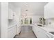 Bright kitchen features white cabinets, quartz countertops, stainless steel sink, and an open layout at 3186 Mapleshade St, Deltona, FL 32738