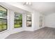 Inviting living area featuring new flooring, large windows, and neutral paint for an airy atmosphere at 3186 Mapleshade St, Deltona, FL 32738