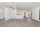 Open-concept living area with modern flooring, neutral walls, and seamless flow to the kitchen at 3186 Mapleshade St, Deltona, FL 32738