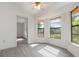 Bright living room featuring new gray flooring, large windows, and neutral paint at 3186 Mapleshade St, Deltona, FL 32738