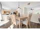 Dining area with light wood table and kitchen view at 525 Aster Dr, Davenport, FL 33897