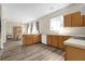 Kitchen features light wood cabinets, white appliances, and vinyl flooring at 525 Aster Dr, Davenport, FL 33897