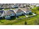 Aerial view of two homes with backyard and solar panels at 720 Split Hoof Dr, Saint Cloud, FL 34771