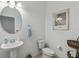 Clean and modern bathroom with a toilet, sink, and decorative accents at 720 Split Hoof Dr, Saint Cloud, FL 34771