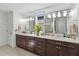 Double vanity bathroom with dark wood cabinets and large mirror at 720 Split Hoof Dr, Saint Cloud, FL 34771