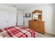 Spacious bedroom with plaid bedding and built-in dresser at 720 Split Hoof Dr, Saint Cloud, FL 34771