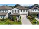 Two-story house with gray and white exterior, gray roof, and a two-car garage at 720 Split Hoof Dr, Saint Cloud, FL 34771