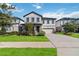 Two-story home with gray siding, landscaping, and a two-car garage at 720 Split Hoof Dr, Saint Cloud, FL 34771