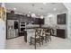 Modern kitchen with dark cabinets, granite counters, and stainless steel appliances at 720 Split Hoof Dr, Saint Cloud, FL 34771