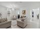 Spacious living room with beige sofas and a view into the kitchen at 720 Split Hoof Dr, Saint Cloud, FL 34771