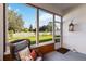 Bright sunroom, wicker chair and view of backyard at 720 Split Hoof Dr, Saint Cloud, FL 34771