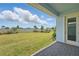 A well maintained grassy backyard with a neutral colored fence and patio at 13163 Mcmillan Dr, Orlando, FL 32827